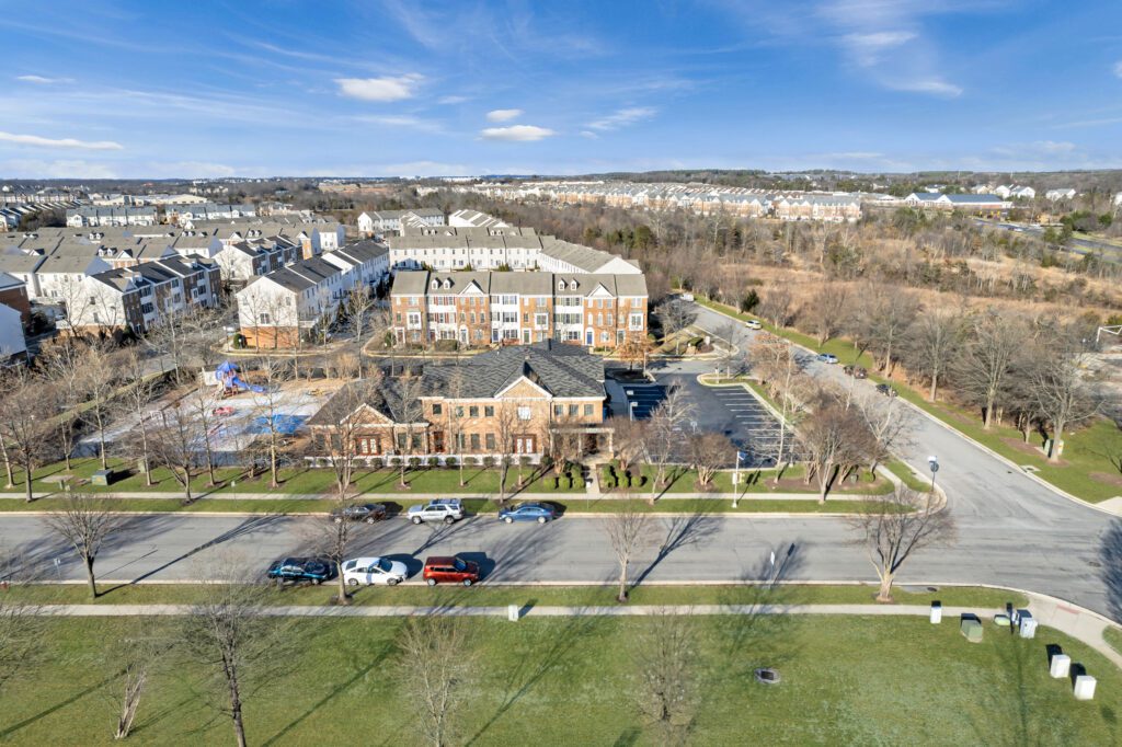 Aerial view of the early education childcare center at 42851 Smallwood Terrace, Chantilly, VA, listed by Serafin Real Estate, featuring a playground and parking in a residential area